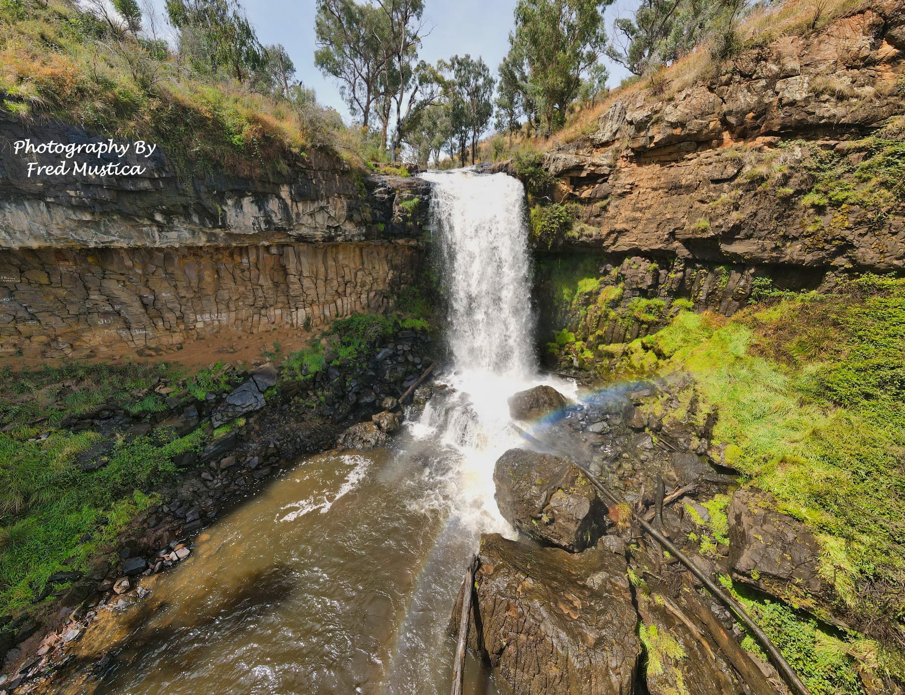 Aerial view of a waterfall tumbling into a rocky gorge