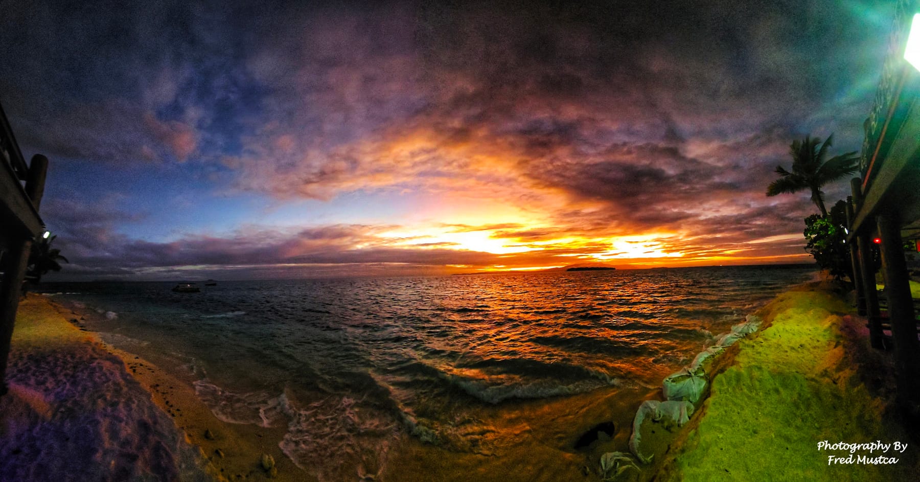 Vivid orange sunrise over the water, photographed by Fred
